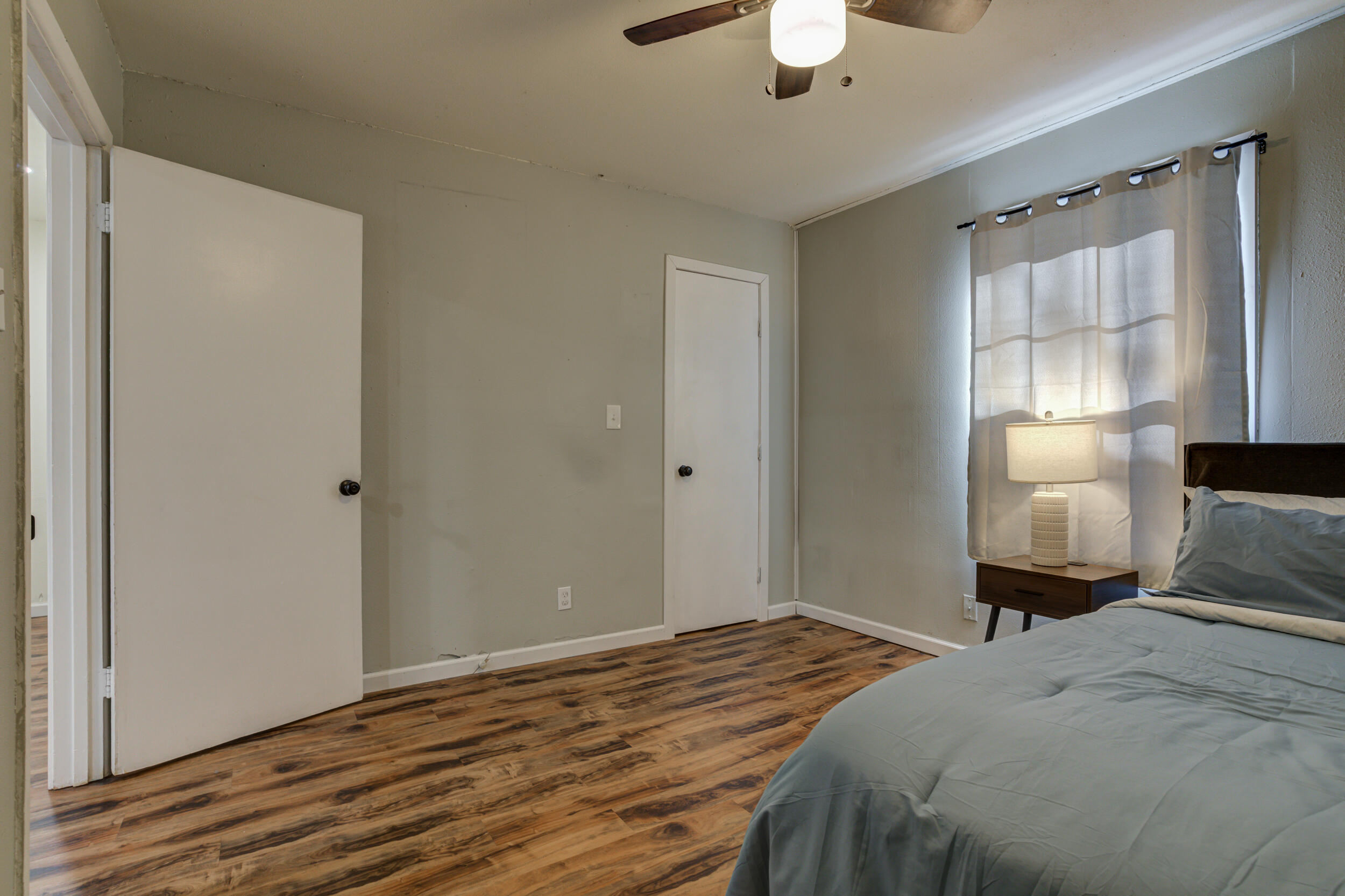 4609 Elgin Avenue Lubbock, TX 79413 - Photo 26 of 46 a bedroom with a bed and a chandelier