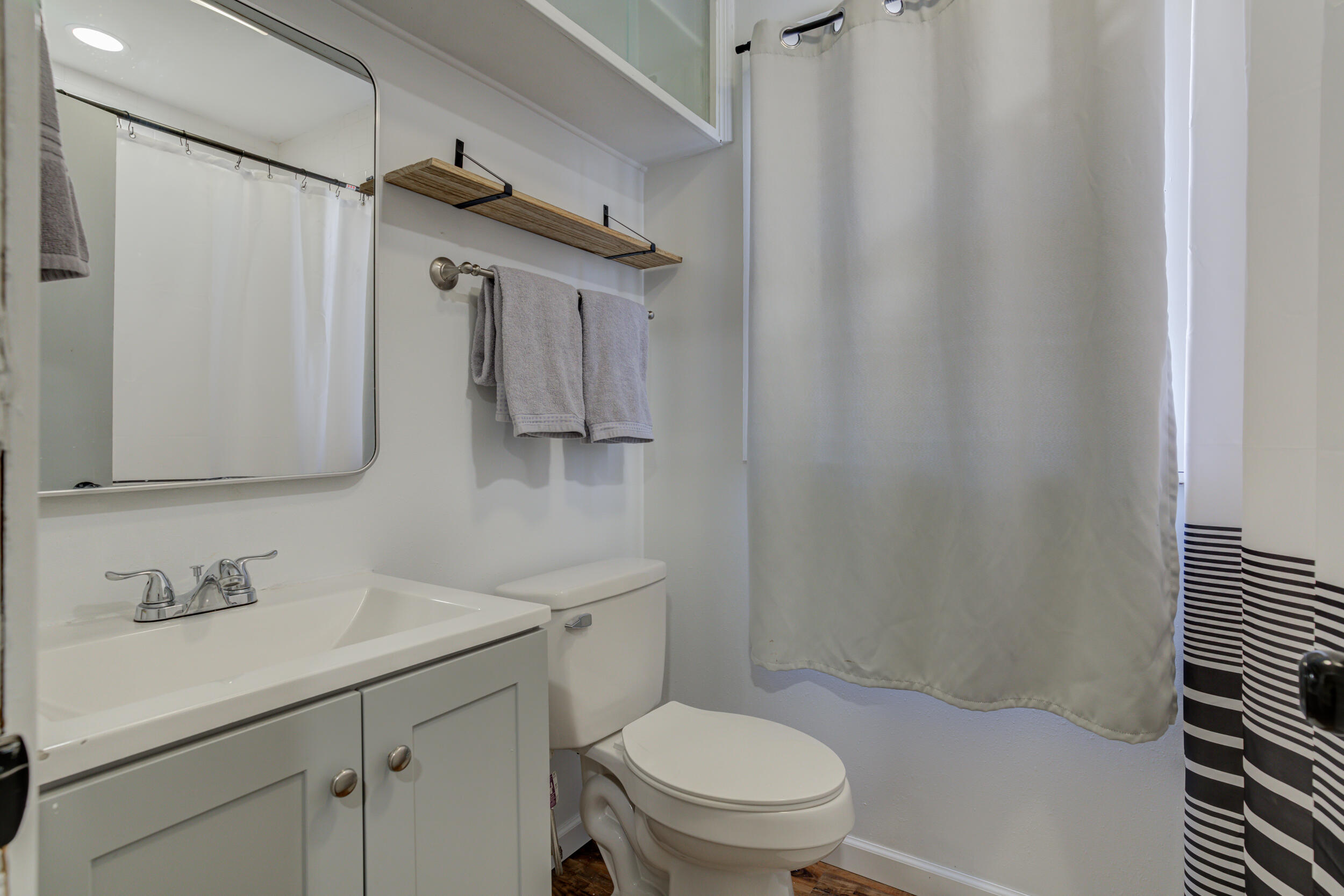 4609 Elgin Avenue Lubbock, TX 79413 - Photo 27 of 46 a bathroom with a sink toilet and shower