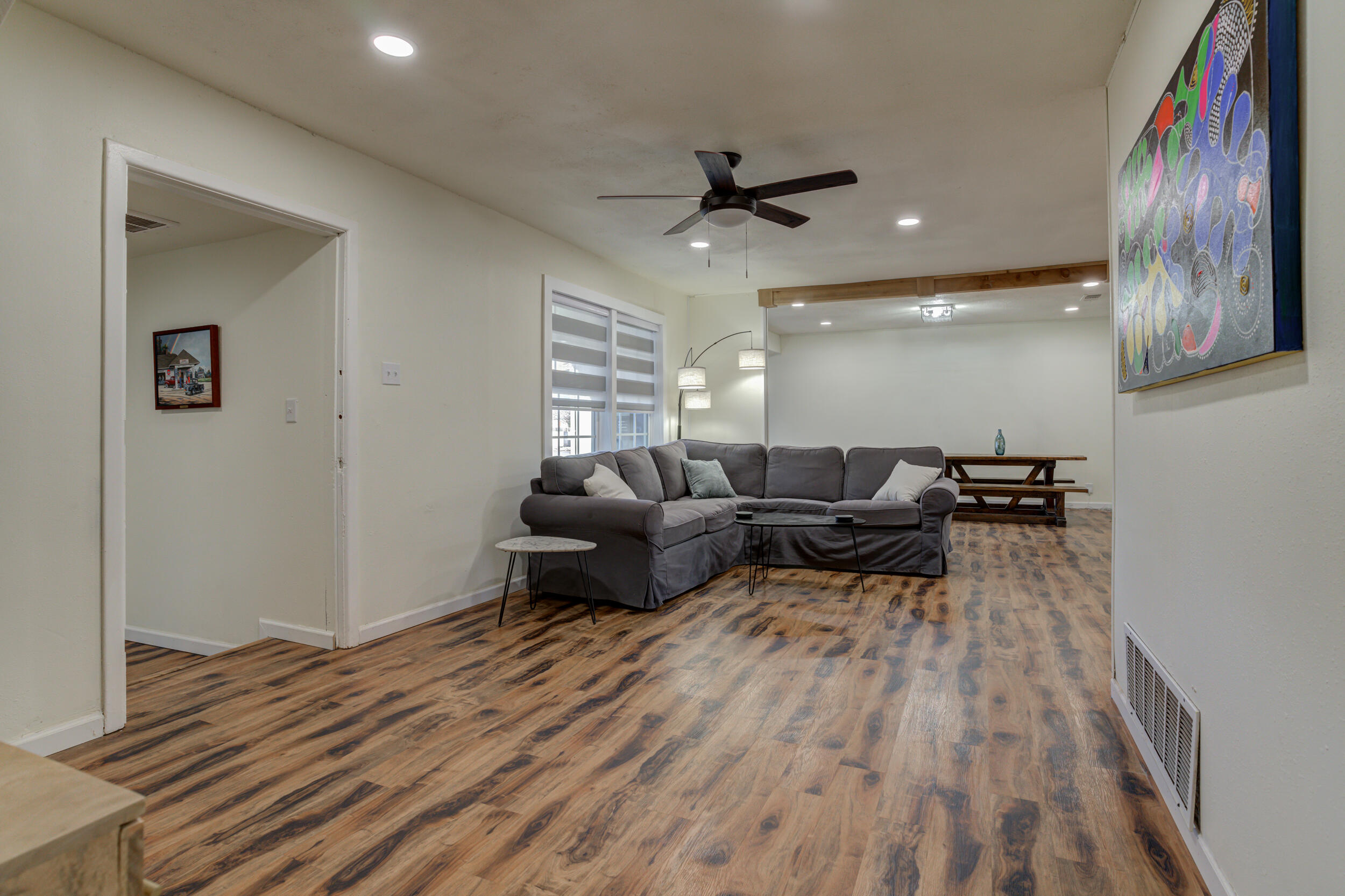 4609 Elgin Avenue Lubbock, TX 79413 - Photo 30 of 46 a living room with furniture and a wooden floor