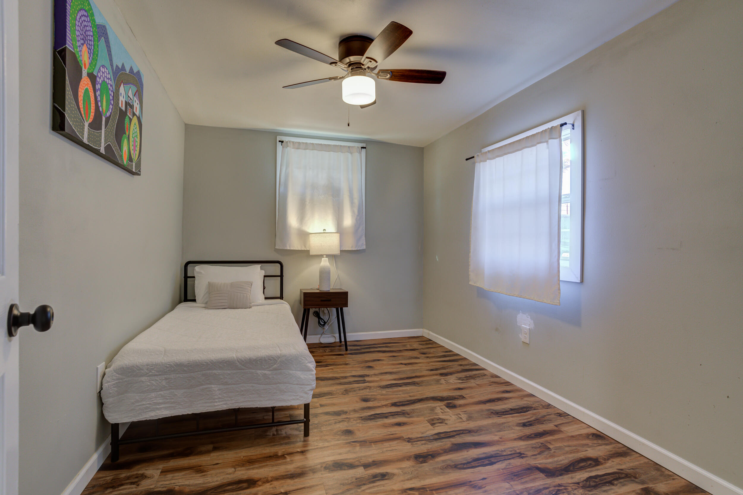 4609 Elgin Avenue Lubbock, TX 79413 - Photo 32 of 46 a bedroom with a bed and a table in it