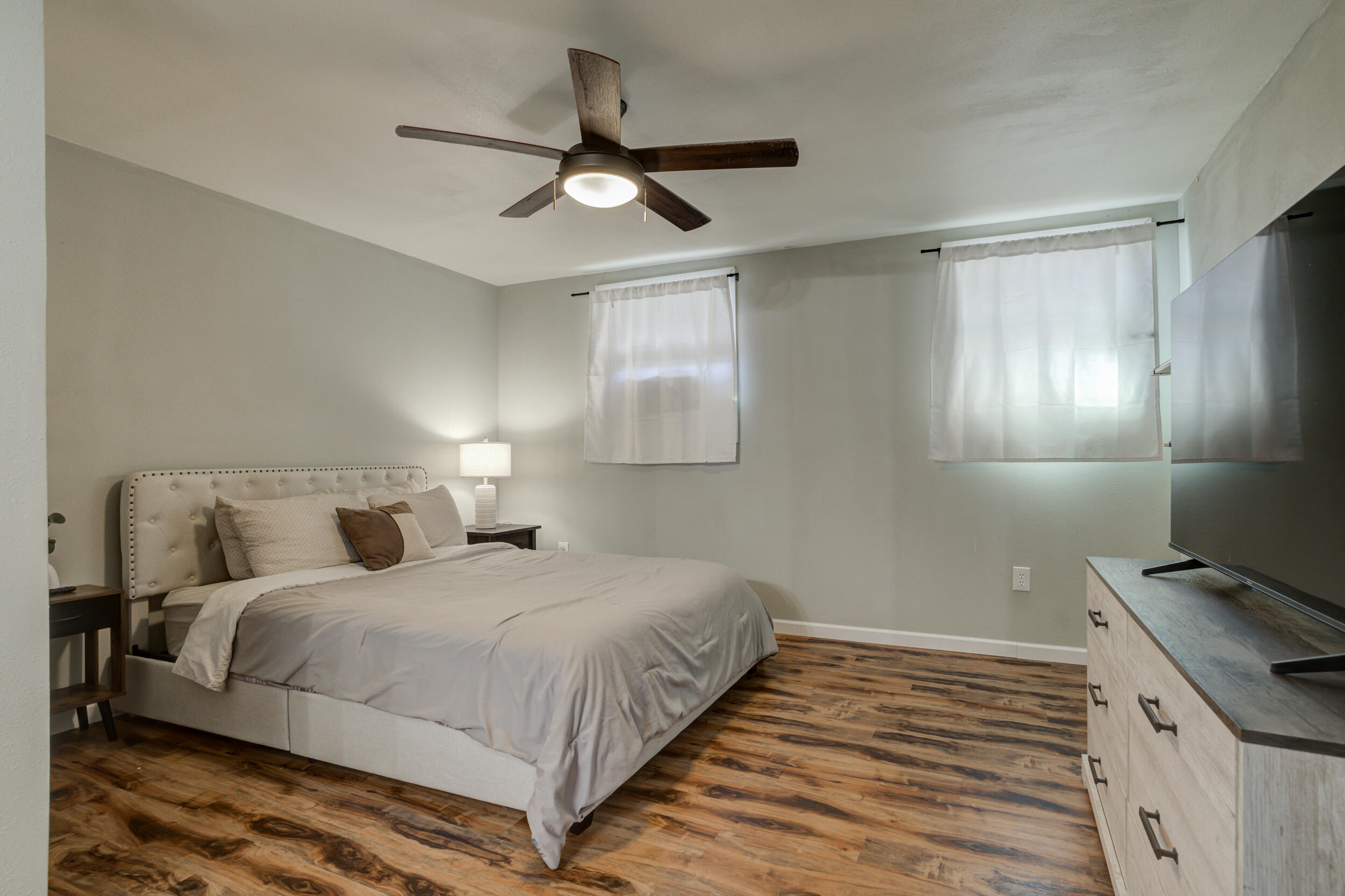 4609 Elgin Avenue Lubbock, TX 79413 - Photo 34 of 46 a bedroom with a bed and a ceiling fan