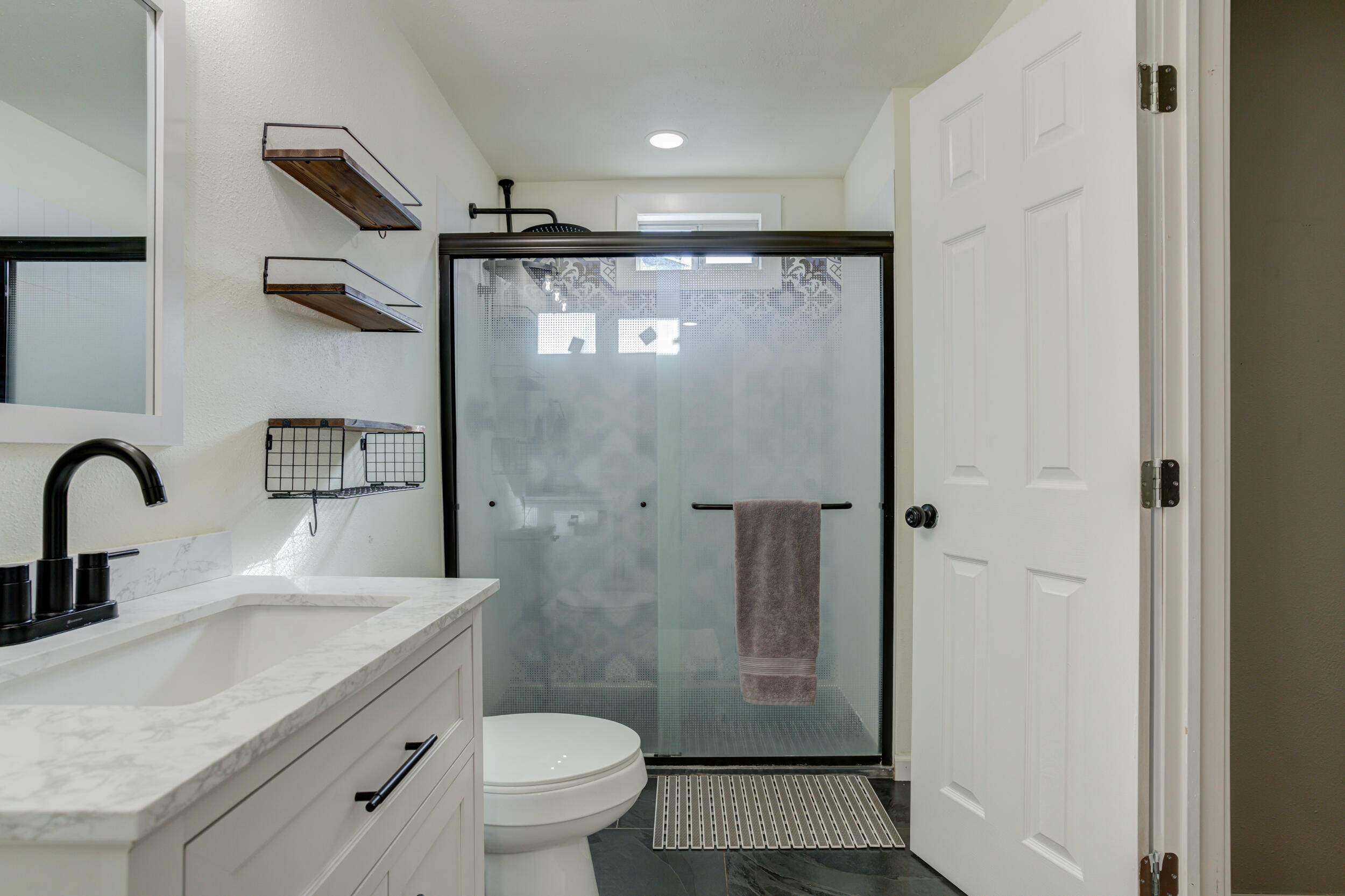 4609 Elgin Avenue Lubbock, TX 79413 - Photo 38 of 46 a bathroom with a sink toilet and shower