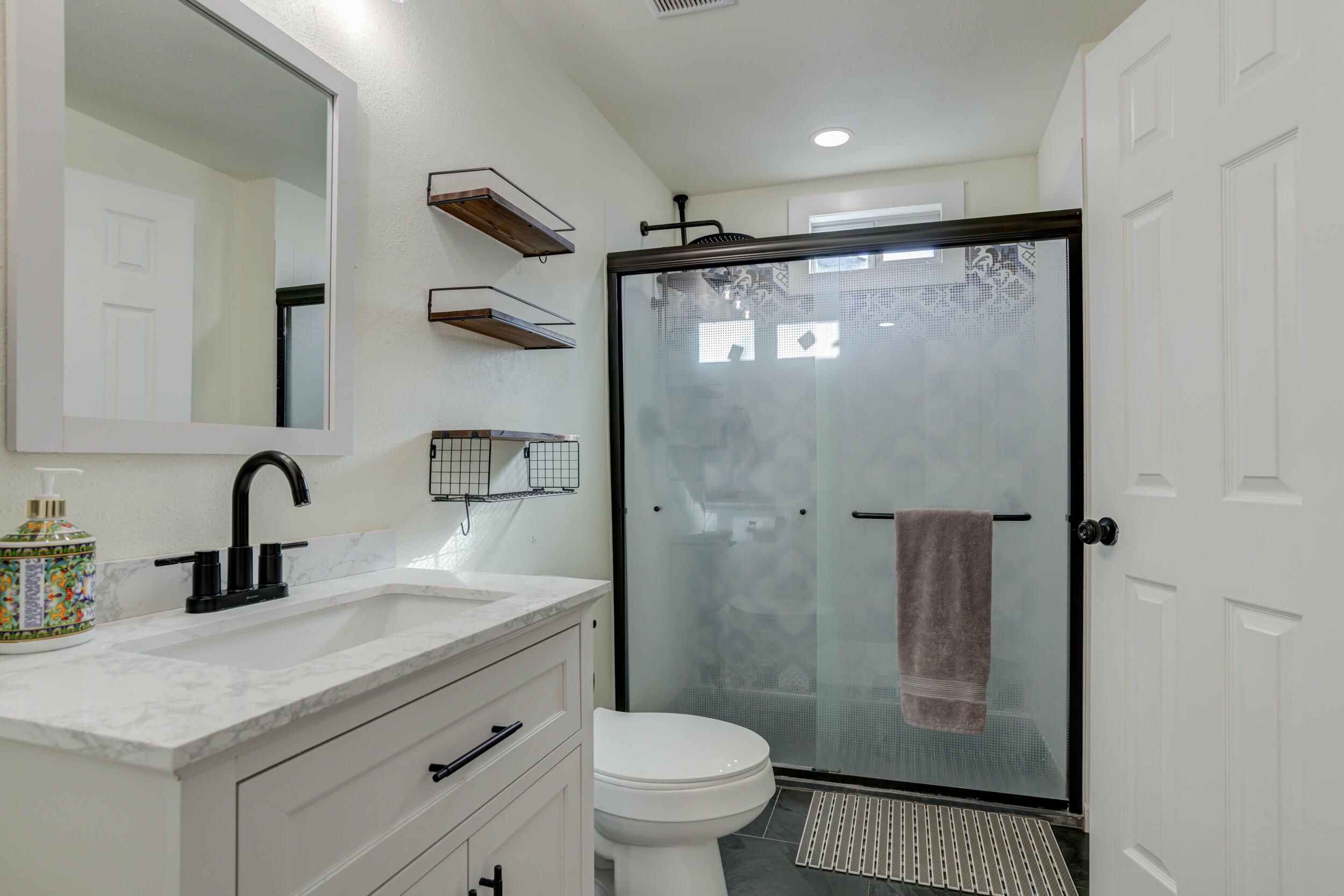 4609 Elgin Avenue Lubbock, TX 79413 - Photo 39 of 46 a bathroom with a sink a toilet and shower