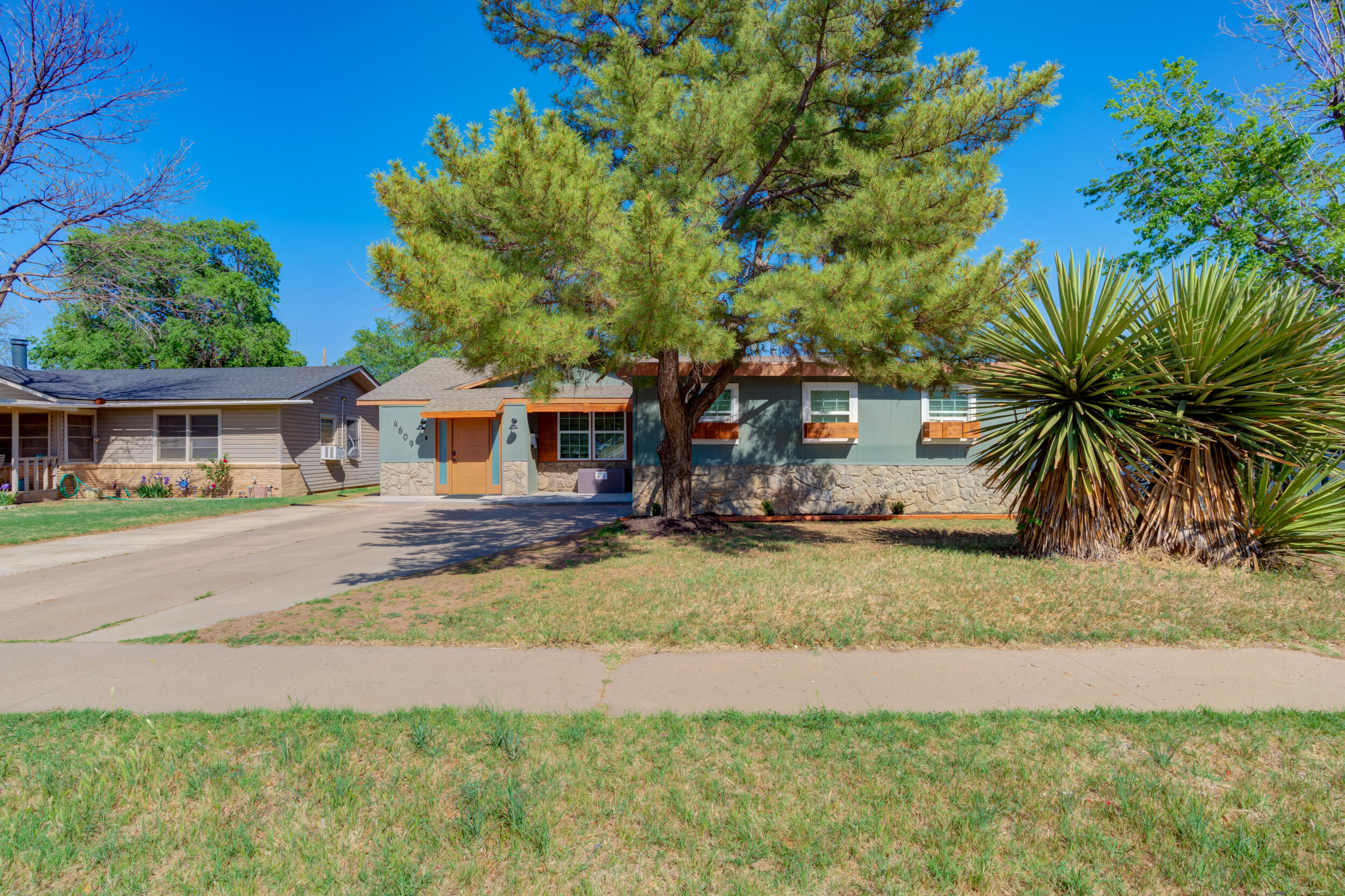 4609 Elgin Avenue Lubbock, TX 79413 - Photo 5 of 46 a front view of house with yard and trees around