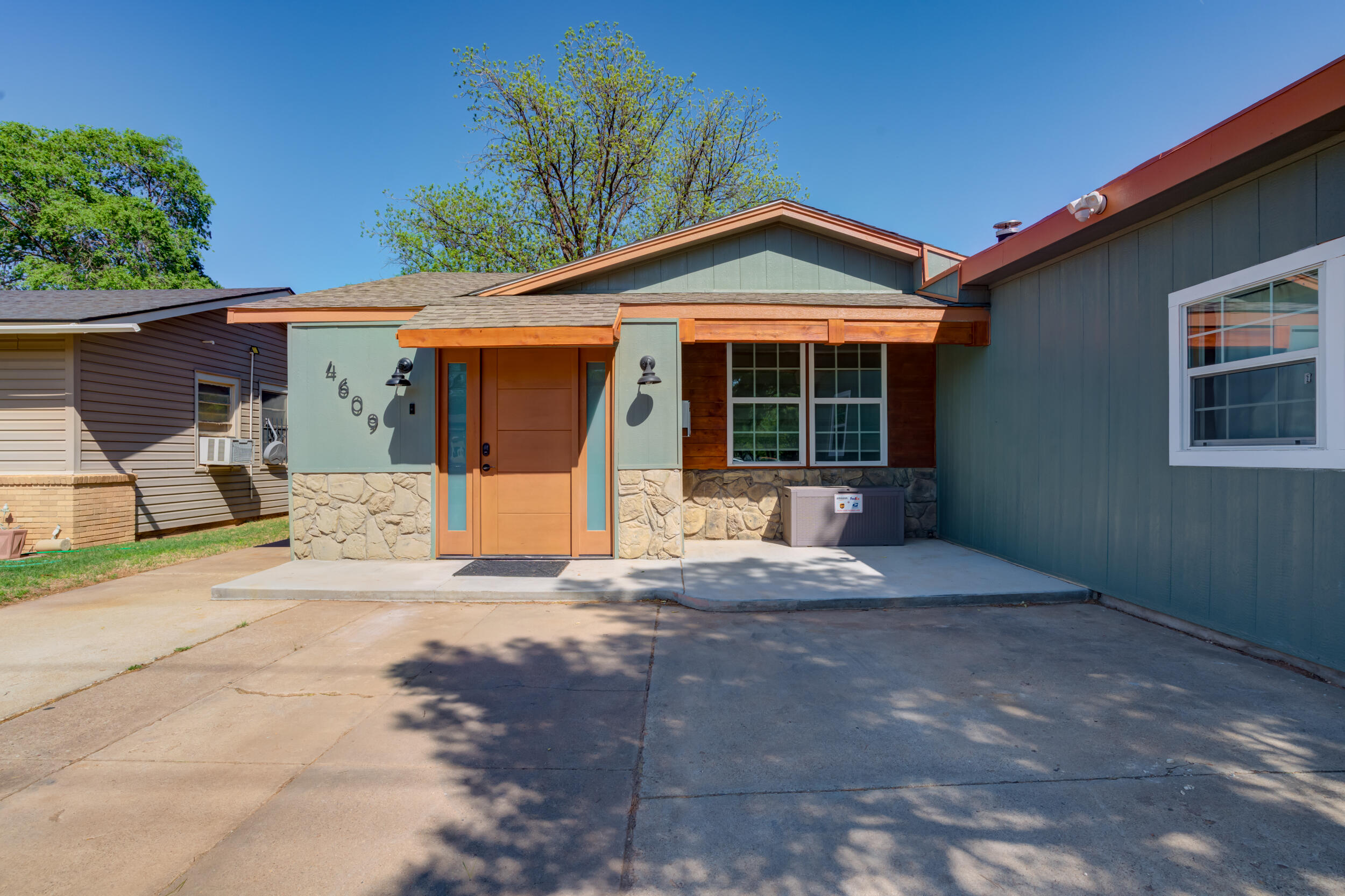 4609 Elgin Avenue Lubbock, TX 79413 - Photo 6 of 46 a front view of a house with a yard and garage
