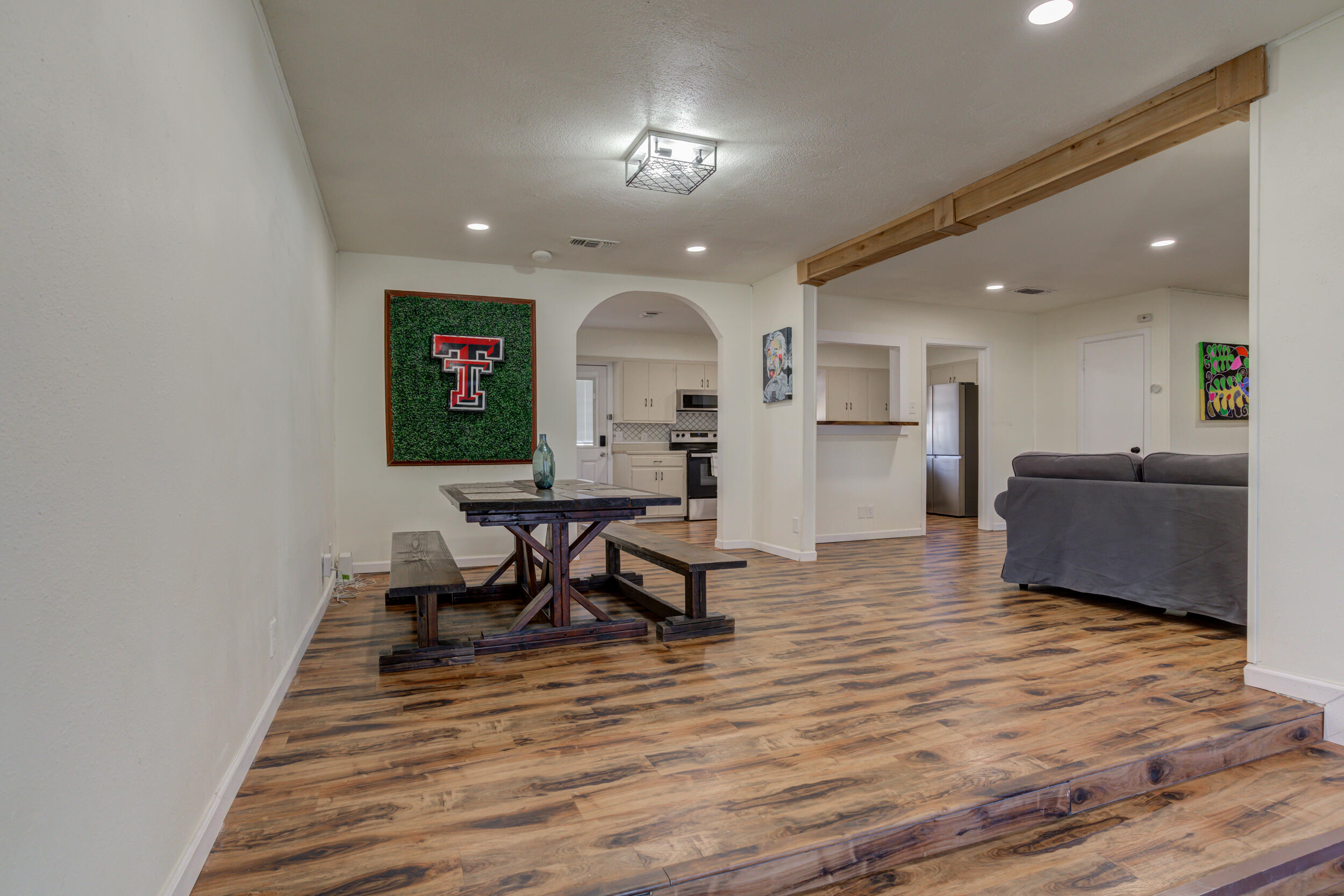 4609 Elgin Avenue Lubbock, TX 79413 - Photo 8 of 46 a living room with furniture and a wooden floor