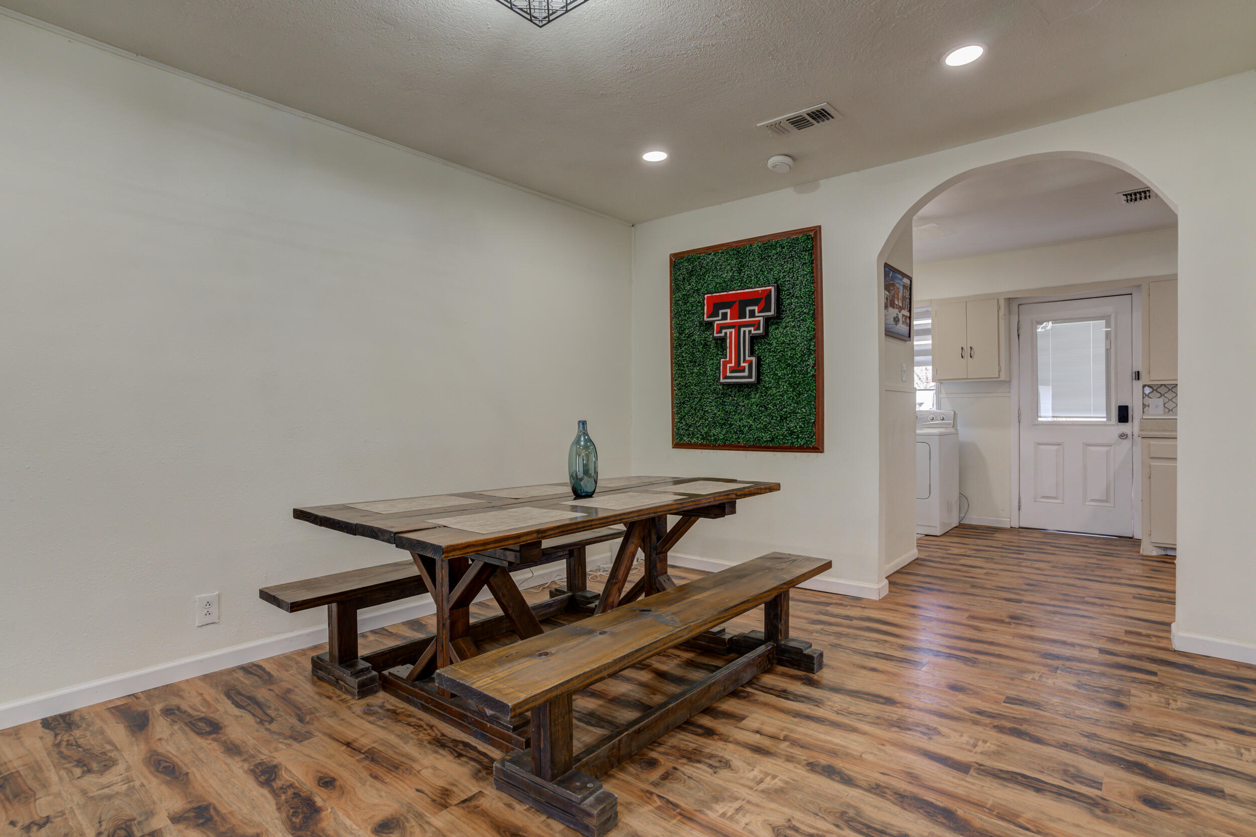 4609 Elgin Avenue Lubbock, TX 79413 - Photo 9 of 46 a view of a livingroom with furniture and wooden floor