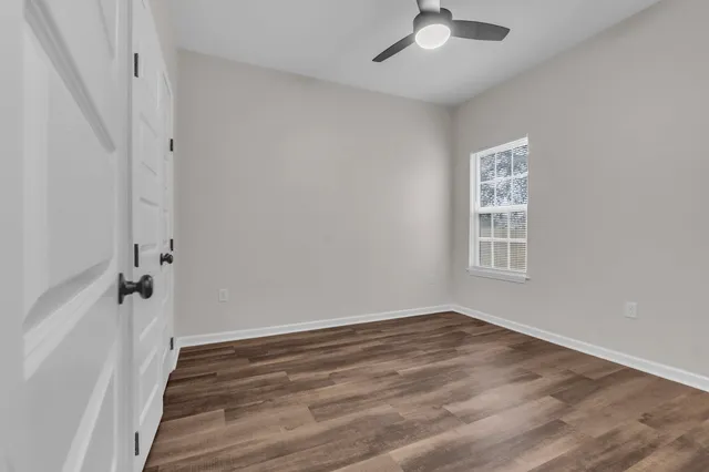 wooden floor in an empty room with a window