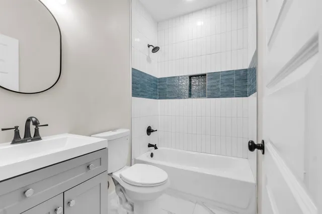 a bathroom with a sink a toilet and bathtub
