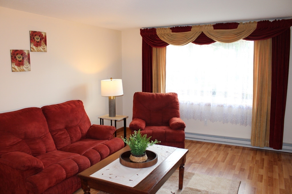 28 State Street Chicopee, MA 01013 - Photo 11 of 25 a living room with furniture and a window