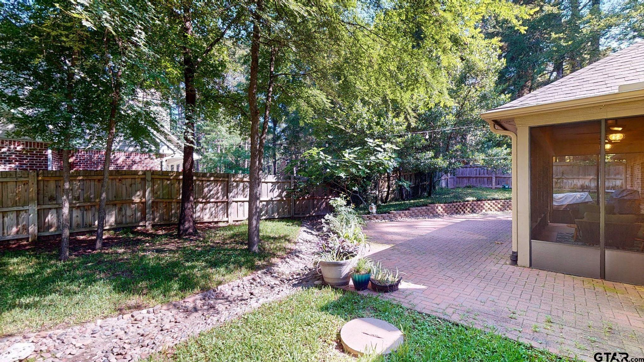 18488 Bluebird Circle Flint, TX 75762 - Photo 37 of 47 a view of a patio with table and chairs potted plants and large tree