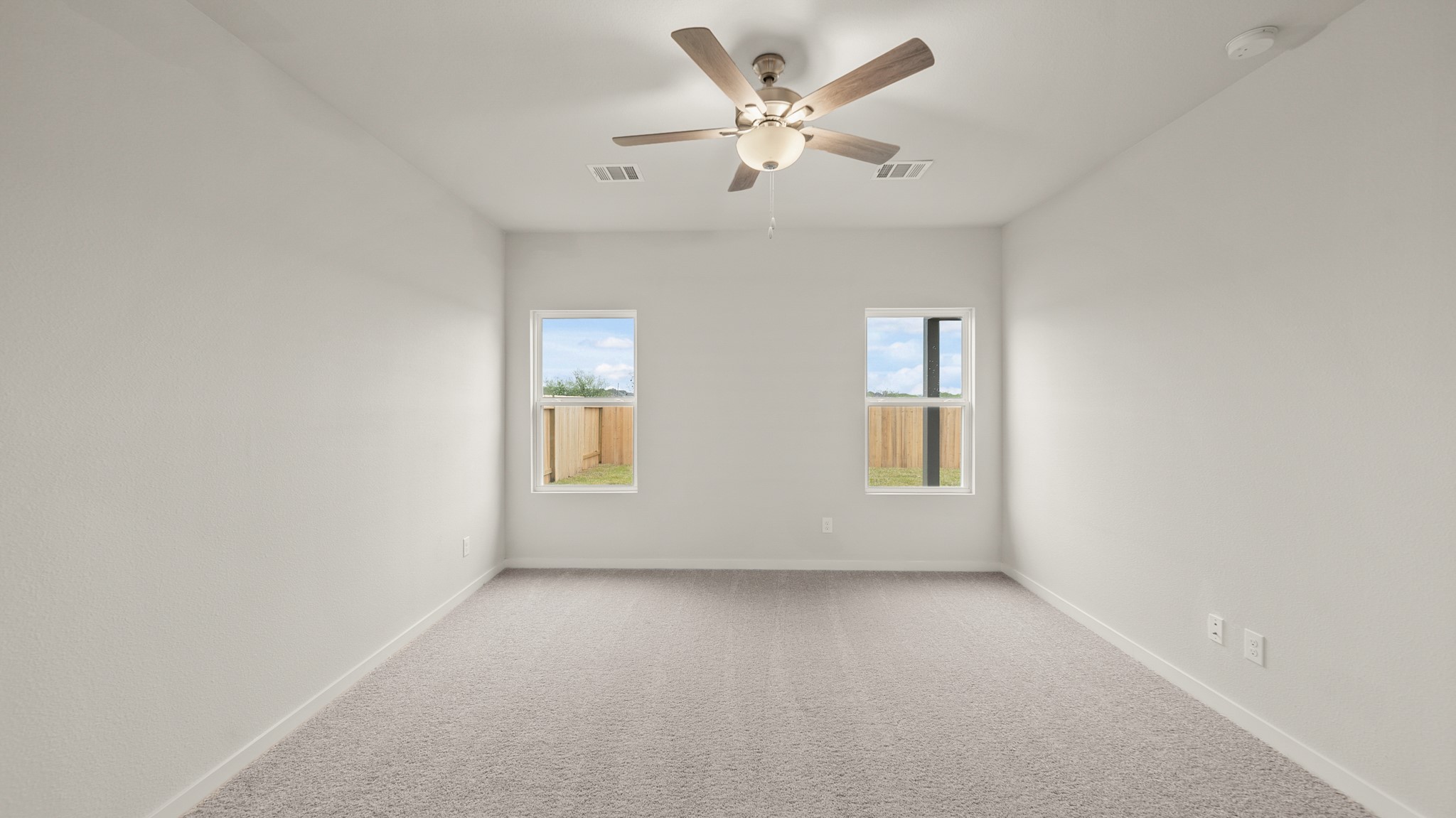 26051 Spiney Thistle Road Katy, TX 77493 - Photo 12 of 22 an empty room with a window and a ceiling fan