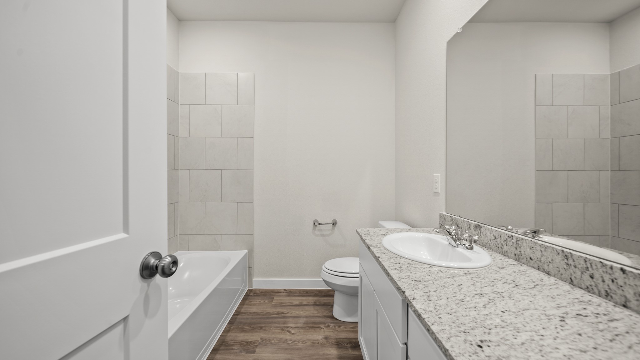 26051 Spiney Thistle Road Katy, TX 77493 - Photo 17 of 22 a bathroom with a granite countertop sink a mirror and a toilet