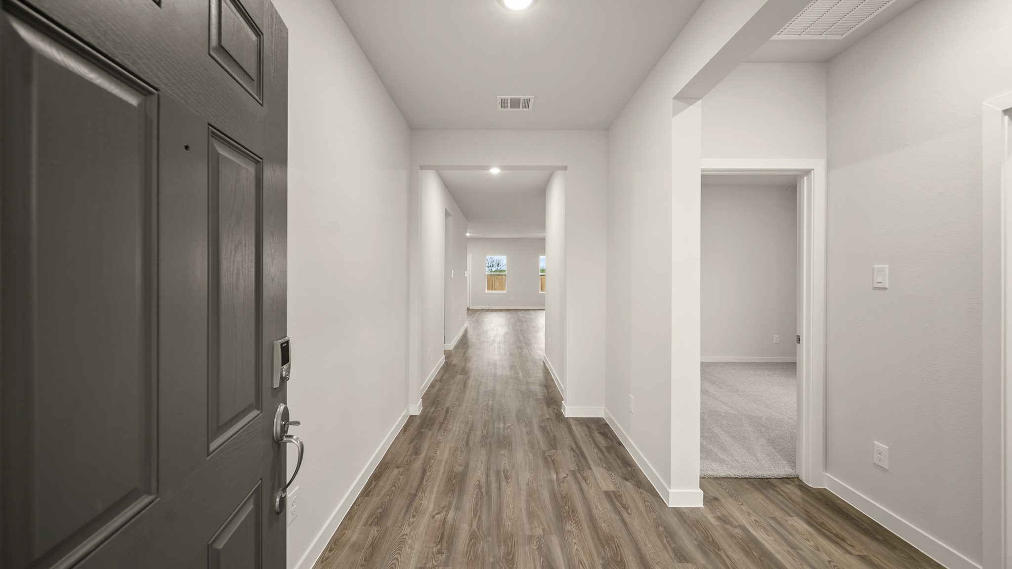 26051 Spiney Thistle Road Katy, TX 77493 - Photo 3 of 22 a view of a hallway with wooden floor