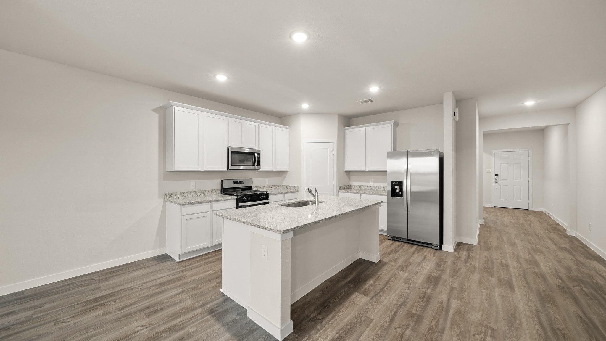 26051 Spiney Thistle Road Katy, TX 77493 - Photo 5 of 22 a kitchen with stainless steel appliances a sink stove and refrigerator