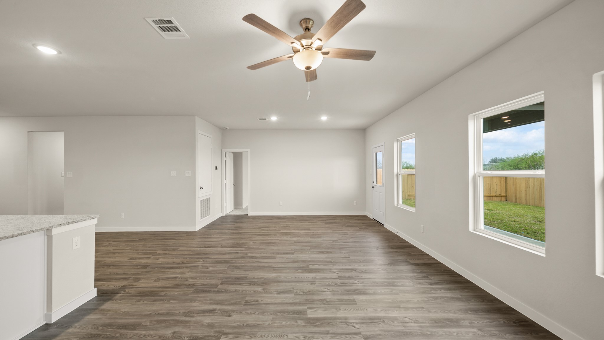 26051 Spiney Thistle Road Katy, TX 77493 - Photo 9 of 22 a view of an empty room with a window and a ceiling fan