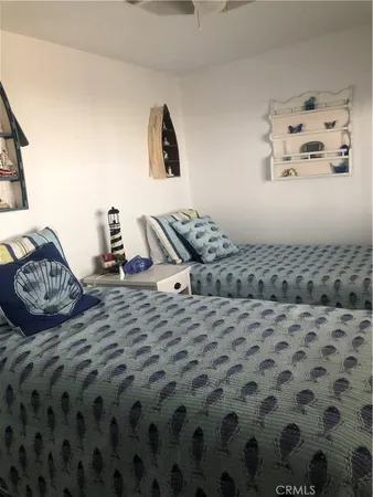 a bedroom with a bed and painting on the wall