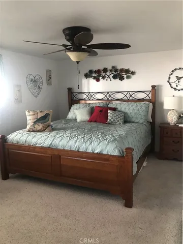 a bedroom with bed and a chandelier