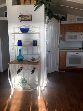 a kitchen with stainless steel appliances wooden floors and sink