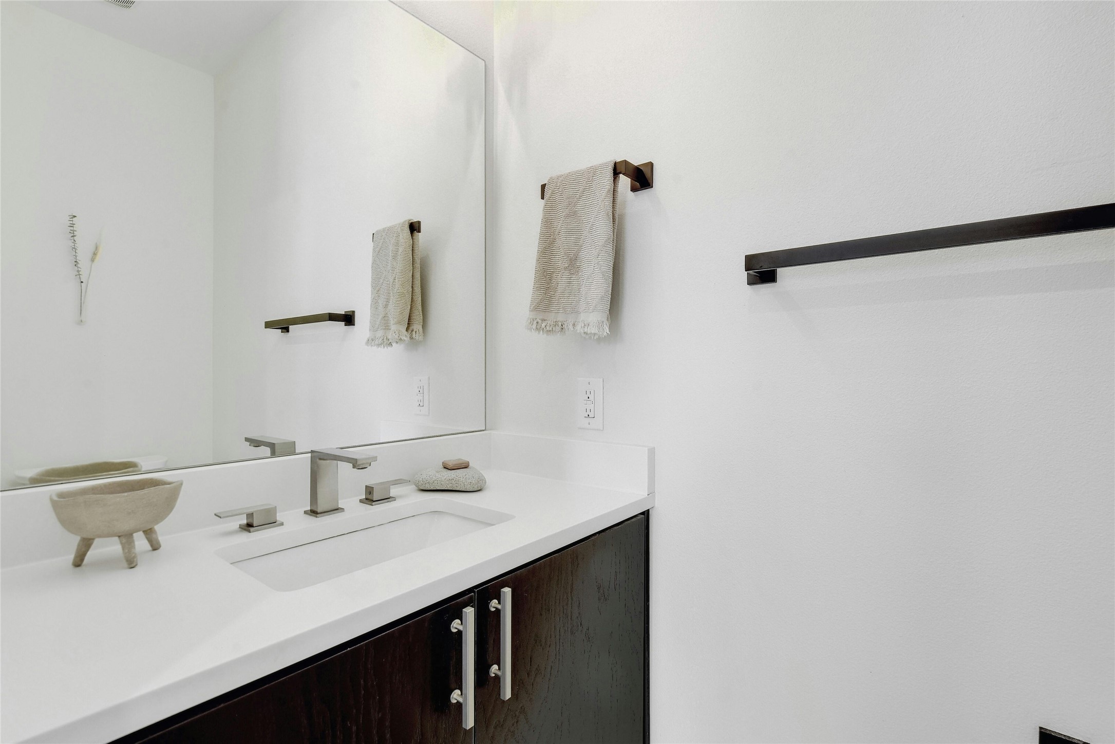 4606 Ledesma Road, Unit 2 Austin, TX 78721 - Photo 15 of 33 A sleek vanity with integrated sink and brushed nickel fixtures defines this modern bathroom space.