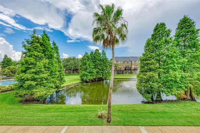 a kitchen with stainless steel appliances granite countertop a refrigerator a stove top oven a sink and dishwasher