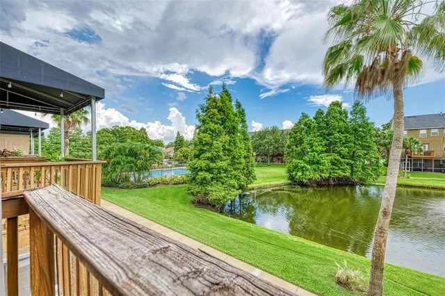 a kitchen with stainless steel appliances granite countertop a refrigerator a sink dishwasher a stove and white countertops with wooden floor