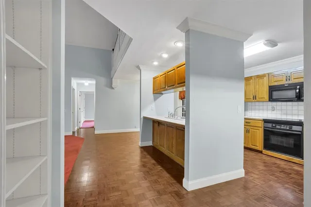 a large kitchen with stainless steel appliances granite countertop a refrigerator and a sink