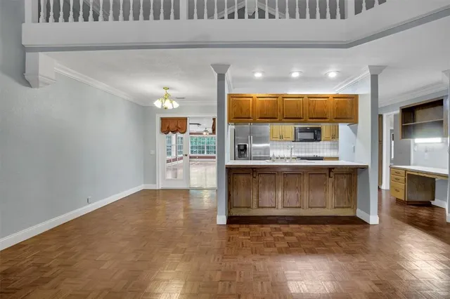 a kitchen with kitchen island granite countertop wooden cabinets and a fireplace