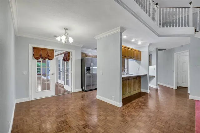 a kitchen with a wooden floor and a window