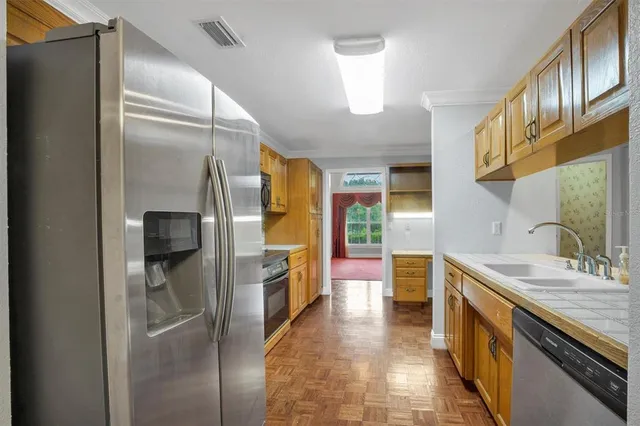 a kitchen with stainless steel appliances granite countertop cabinets and window