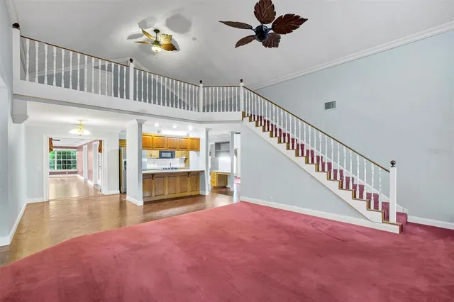 a view of a livingroom with a ceiling fan and window