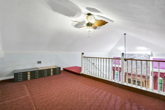 a view of a livingroom with a ceiling fan and window