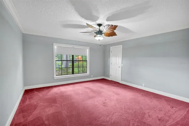 a view of a livingroom with a ceiling fan and window