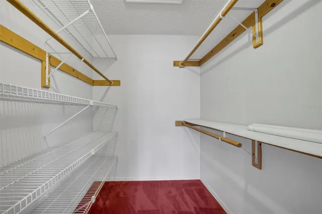 a spacious bathroom with a granite countertop sink and a mirror