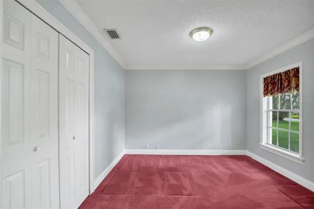 a view of a livingroom with wooden floor and bathroom
