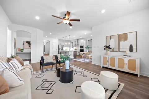 a living room with furniture and kitchen view