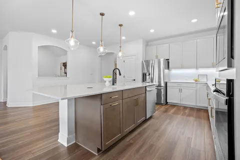 a large kitchen with a lot of counter space and a sink