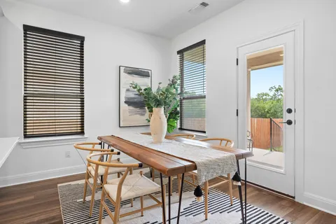 a dining room with furniture and wooden floor