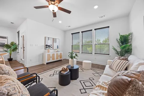 a living room with furniture and a large window