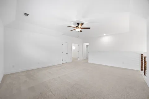 an empty room with a empty space and a ceiling fan