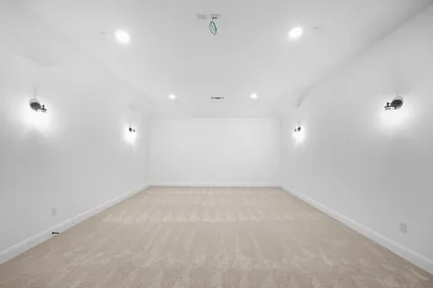 an empty room with a ceiling fan and a window