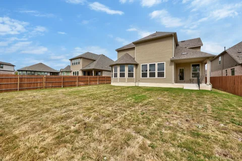 a big house with a big yard and large trees