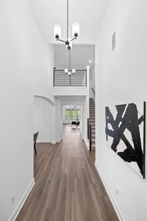 a view of a livingroom with wooden floor and staircase