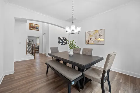 a view of a dining room with furniture wooden floor and chandelier