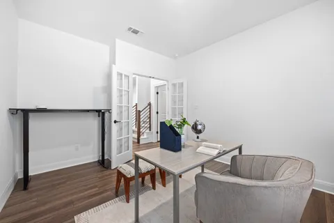 a living room with furniture and wooden floor