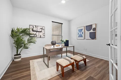 a view of a livingroom with furniture and a potted plant