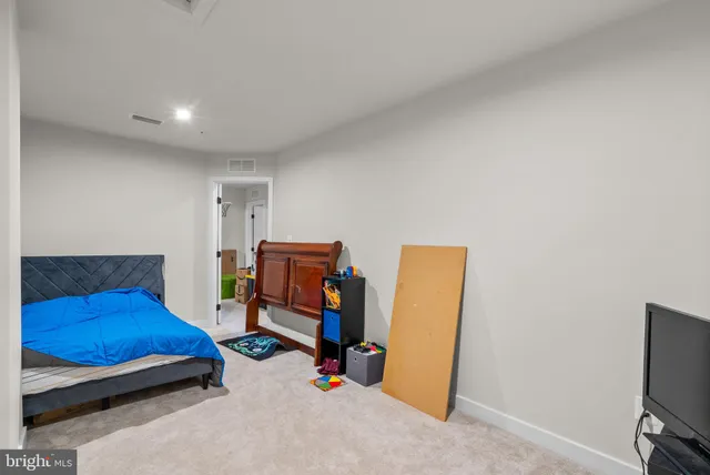 a bedroom with a bed and a tv