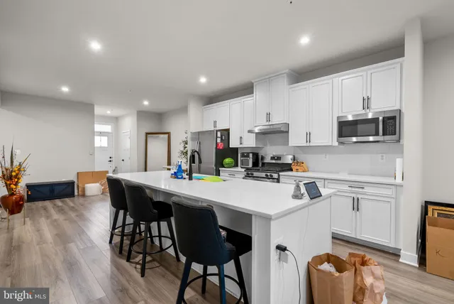 a living room with furniture a piano and a flat screen tv