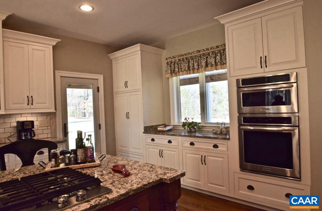 2852 Milton Road Charlottesville, VA 22902 - Photo 11 of 49 a kitchen with stainless steel appliances granite countertop a stove a sink and a microwave