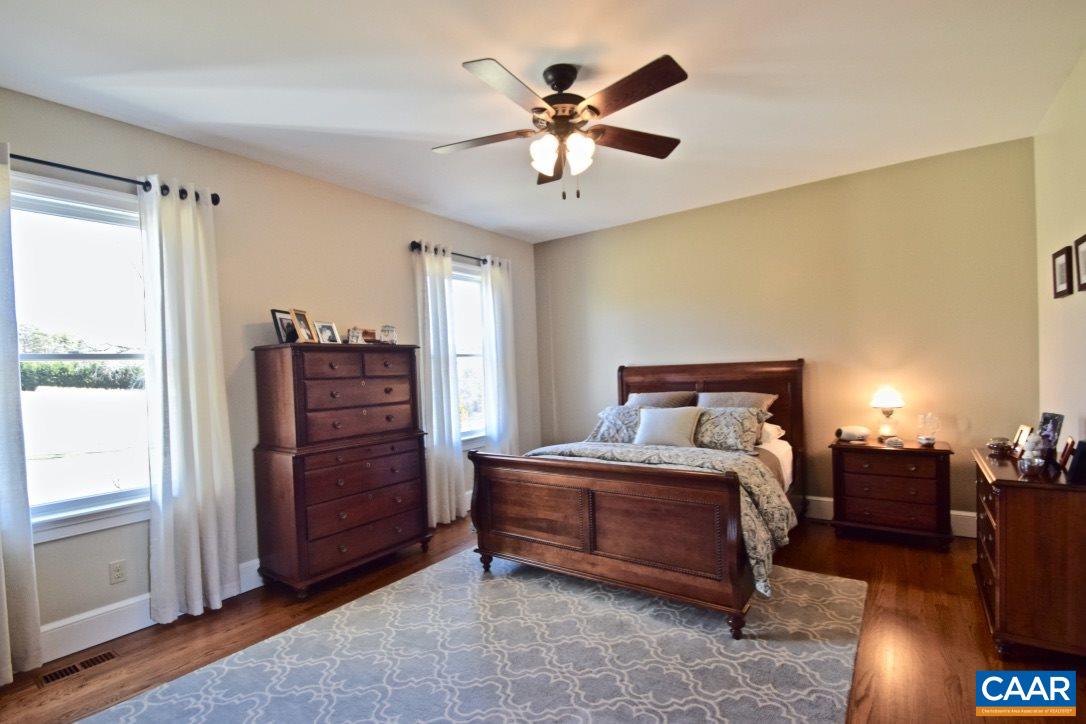 2852 Milton Road Charlottesville, VA 22902 - Photo 16 of 49 a bedroom with a bed and a chandelier